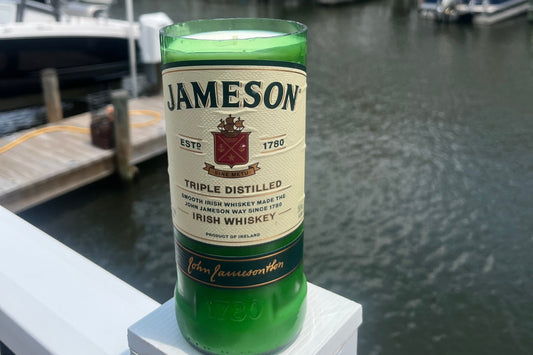 Jameson whiskey bottle on a railing with a blurred background